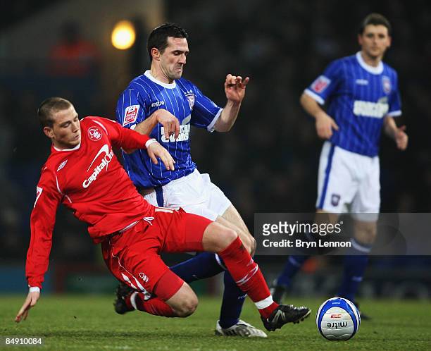Joe Garner of Nottingham Forest tackles David Norris of Ipswich Town during the Coca Cola Championship match between Ipswich Town and Nottingham...