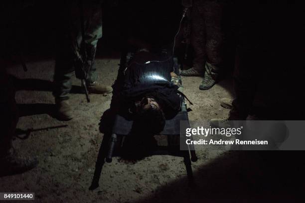Members of the Afghan Special Forces work on a casualty during a casevac night training of Afghanistan Special Forces by the United States Army...
