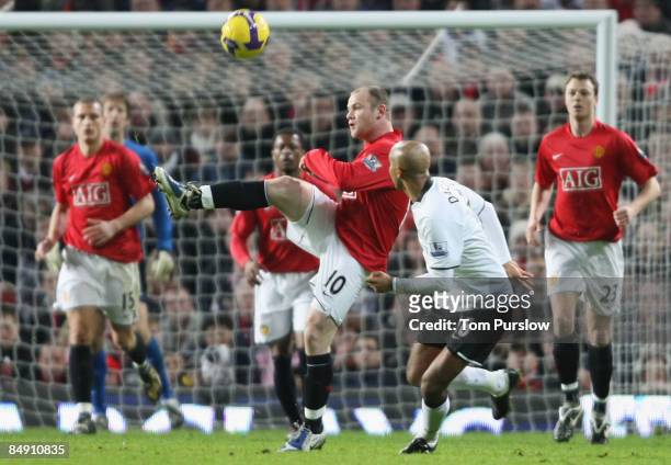 Wayne Rooney of Manchester United clashes with Olivier Dacourt of Fulham during the Barclays Premier League match between Manchester United and...