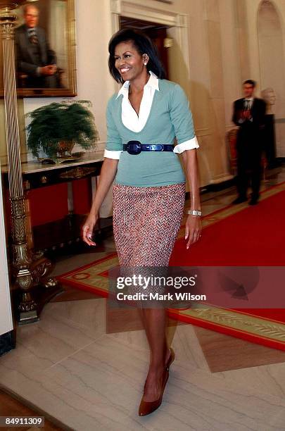 First Lady Michelle Obama walks into the East Room before an event at the White House on February 18, 2009 in Washington, DC. Mrs. Obama hosted an...