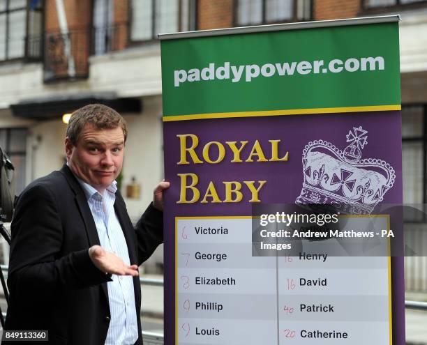 Paddy Power poses with a board of Royal baby names and their odds outside the King Edward VII hospital in London where the Duchess of Cambridge has...