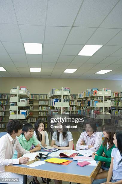 students in library talking at table - file:honolulu stock pictures, royalty-free photos & images