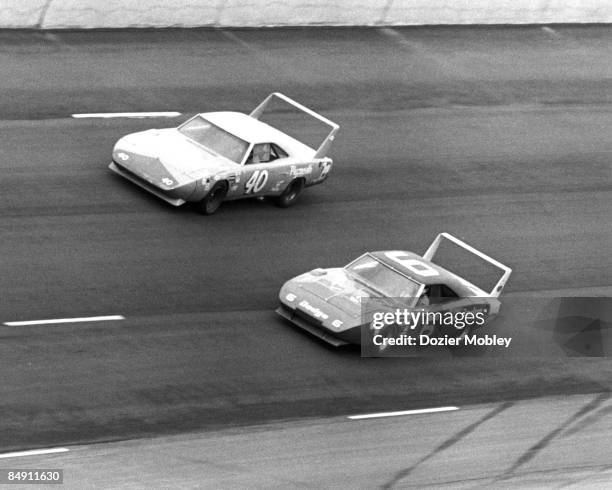 Driver Pete Hamilton in the Plymouth passes Dodge of Buddy Baker on his way to victory at the Alabama 500 race on April 12, 1970 at the Alabama...