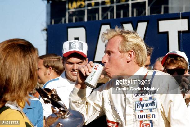 Driver Pete Hamilton sips a 7 Up in Victory Lane after winning the Daytona 500 race on February 22, 1970 at the Daytona International Speedway in...