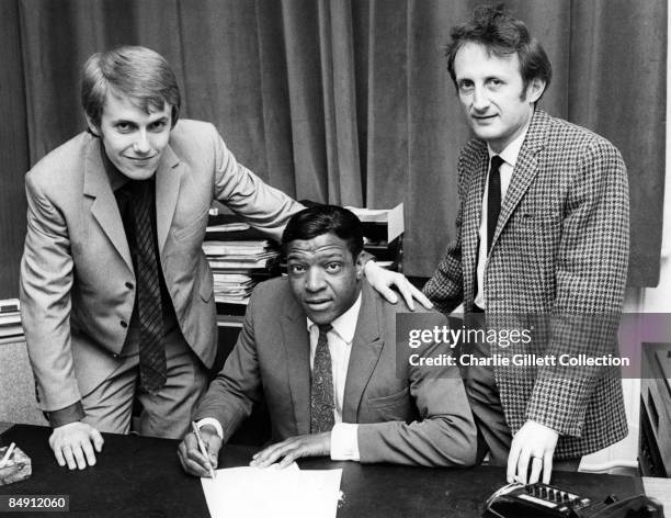 Photo of John ABBEY and Max NEEDHAM and Clyde McPHATTER; Posed behind desk signing contract, with John Abbey & Max Needham,