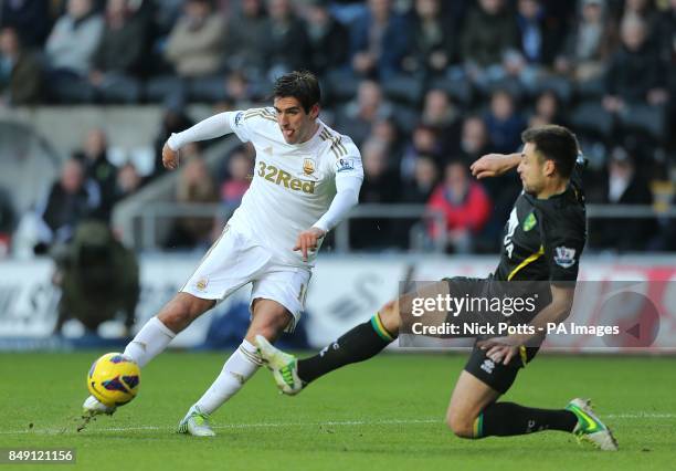 Norwich City's Russell Martin attempts to block a shot by Swansea City's Danny Graham