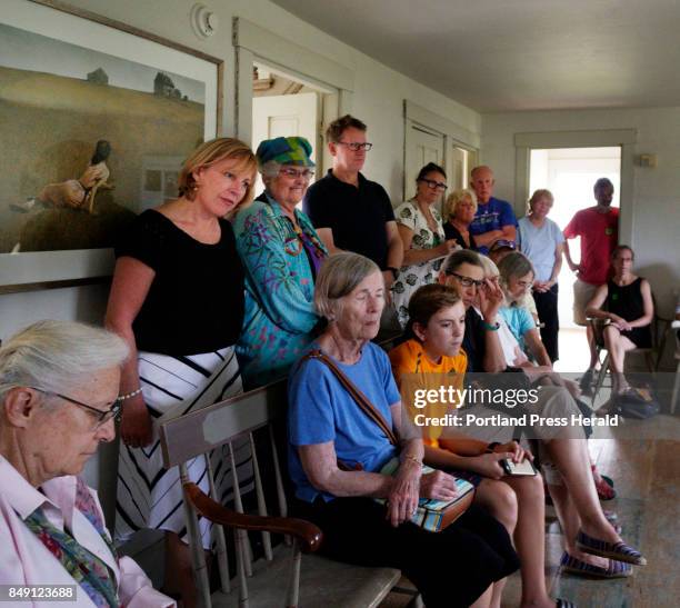 Author Christina Baker Kline stands near a print of Christina's World inside the Olson House in Cushing while listening to David Rockwell, nephew of...