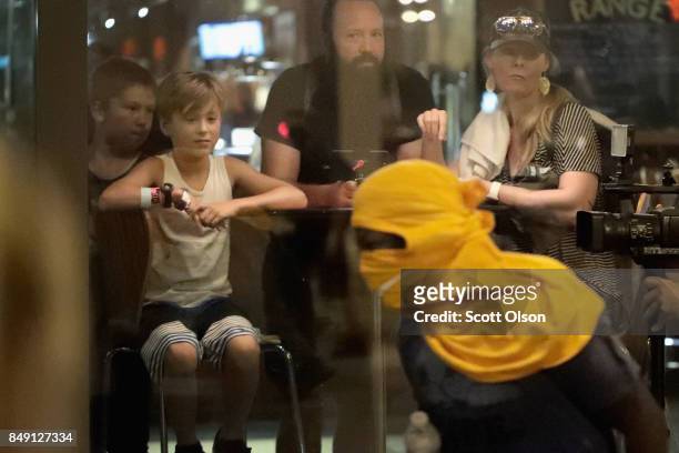 Diners watch as a demonstrator protesting the acquittal of former St. Louis police officer Jason Stockley runs by the front of a restaurant on...