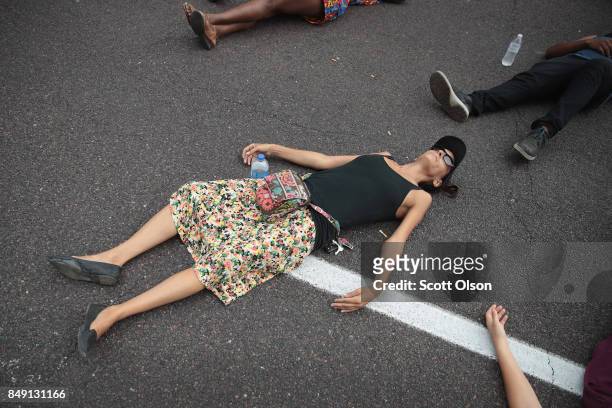 Demonstrators protesting the acquittal of former St. Louis police officer Jason Stockley stage a die-in in front of police headquarters on September...