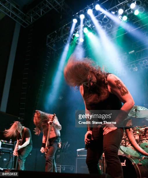 Photo of AMON AMARTH and Johan HEGG and Johan SODERBERG and Ted LUNDSTROM, L-R Johan Soderberg, Ted Lundstrom and Johan Hegg performing on stage