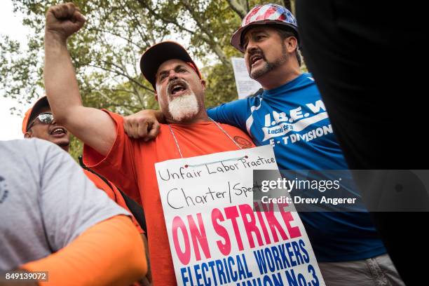 Members of IBEW Local 3 cheer during a rally of hundreds of union members in support of IBEW Local 3 at Cadman Plaza Park, September 18, 2017 in the...