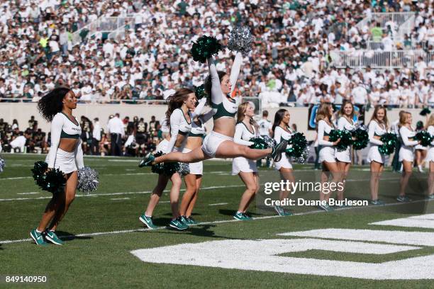 The Spartan Dance Team entertains the crowd during the first half of a game against the Western Michigan Broncos at Spartan Stadium on September 9,...