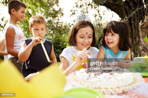 young girls enjoying cake at kids party - birthday girl stock pictures, royalty-free photos & images