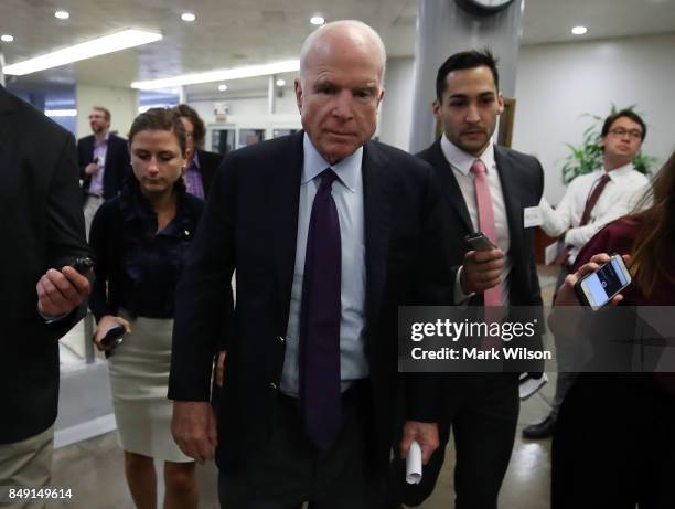 Sen. John McCain is trailed by reporters in the Senate Subway before the Senate takes up the National Defense Authorization Act for FY2018, on...