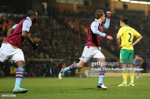 Aston Villa's Brett Holman celebrates scoring his teams first goal of the game with teammate Darren Bent as Norwich City's Russell Martin looks...