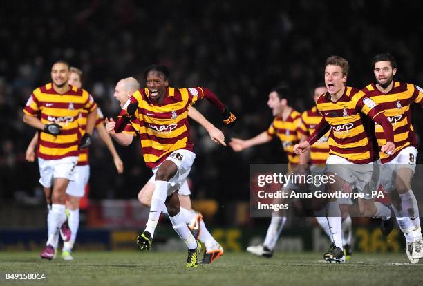 Bradford City players led by Blair Turgott celebrate after winning the match in a penalty shootout after extra time