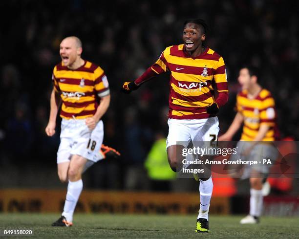 Bradford City players led by Blair Turgott and Gary Jones celebrate after winning the match in a penalty shootout after extra time