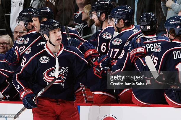 Forward R.J. Umberger of the Columbus Blue Jackets receives congratulations from teammates on the bench after scoring a goal against the Dallas Stars...