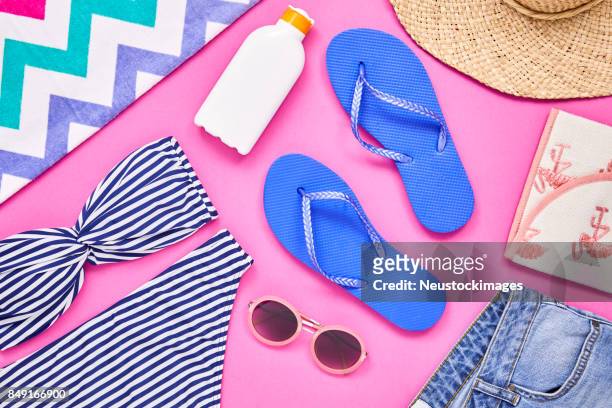 overhead shot of travel and beach equipment on pink background - beach flat lay stock pictures, royalty-free photos & images