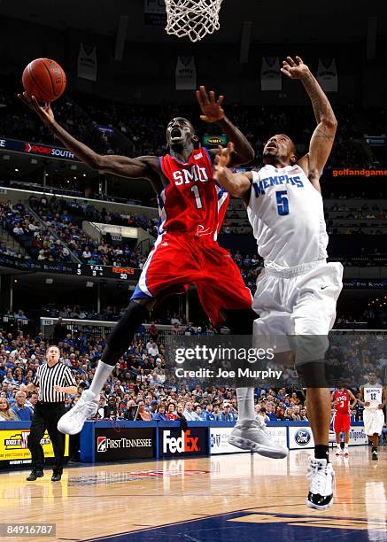 Mouhammad Faye of the Southern Methodist University Mustangs shoots a layup against Antonio Anderson of the Memphis Tigers at FedExForum on February...