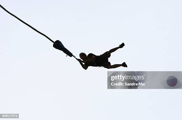 Cam Sinclair holds onto the bungy cord as the Crusty Demons bungee jump off Auckland Harbour Bridge February 19, 2009 in Auckland, New Zealand.