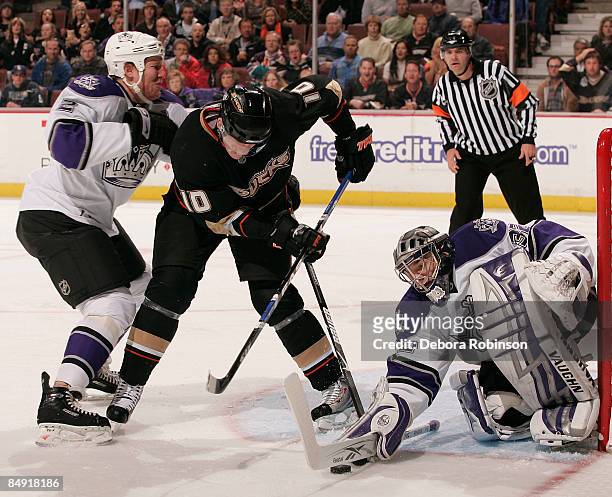 Matt Greene and Jonathan Quick of the Los Angeles Kings defend in the crease against Corey Perry of the Anaheim Ducks during the game on February 18,...
