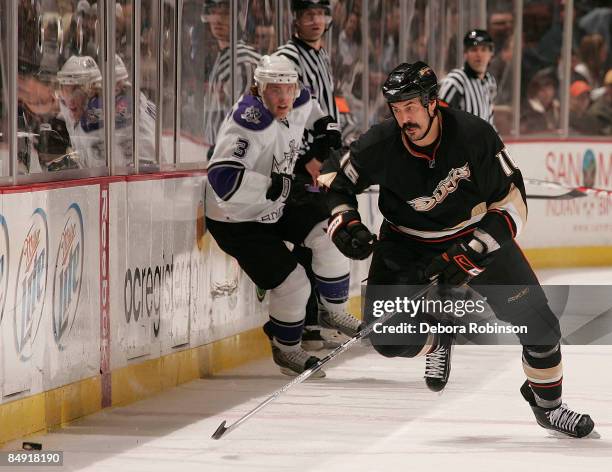 Jack Johnson of the Los Angeles Kings defends against George Parros of the Anaheim Ducks during the game on February 18, 2009 at Honda Center in...