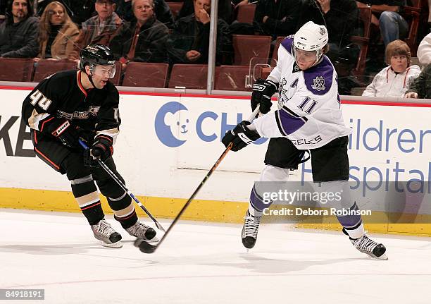 Anze Kopitar of the Los Angeles Kings passes the puck past Rob Niedermayer of the Anaheim Ducks during the game on February 18, 2009 at Honda Center...