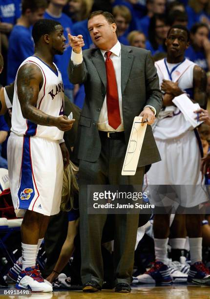 Head coach Bill Self of the Kansas Jayhawks talks with Sherron Collins during the game against the Iowa State Cyclones at Allen Fieldhouse February...