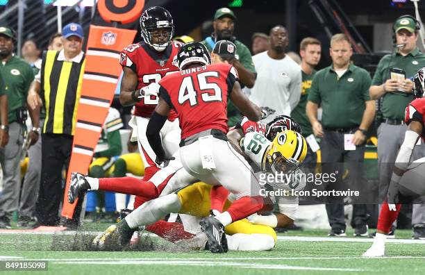 Green Bay Packers tight end Richard Rodgers gets tackled by Atlanta Falcons strong safety Keanu Neal during the NFL game between the Green Bay...