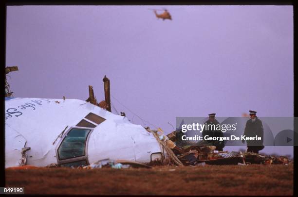 Officials inspect the wreckage of Pan Am flight 103 December 21, 1988 in Lockerbie, Scotland. One hundred and eighty-nine of the two hundred and...