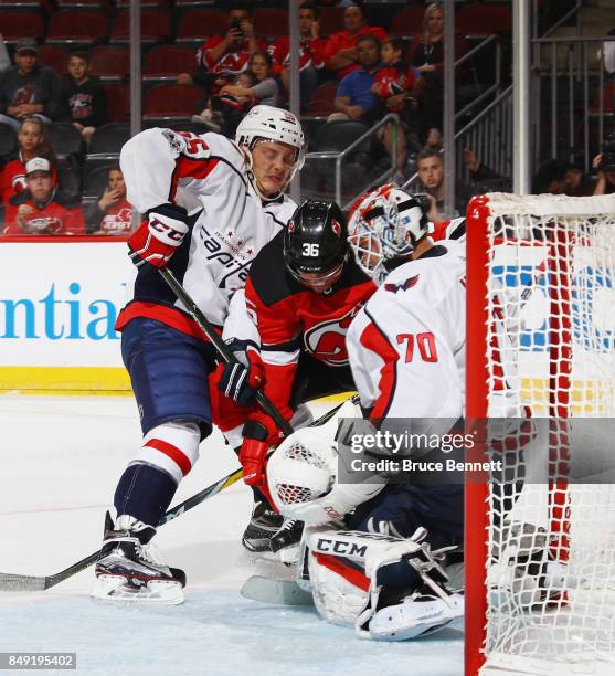 Aaron Ness and Braden Holtby of the Washington Capitals defend against Nick Lappin of the New Jersey Devils during the second period during a...