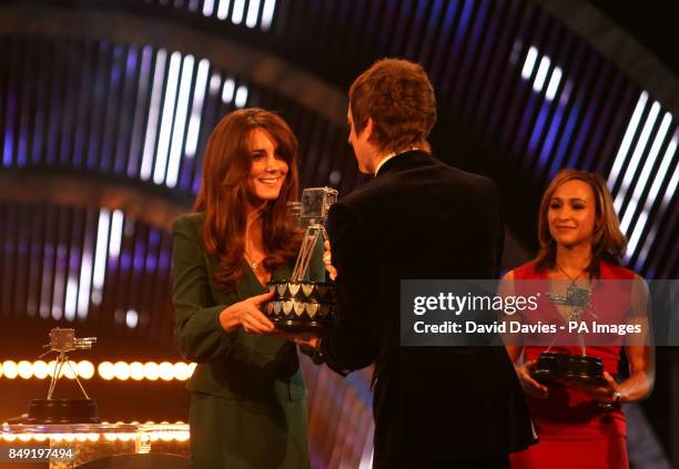 Winner of Sports Personality of the Year 2012, Bradley Wiggins accepts his award onstage from The Duchess of Cambridge during the BBC Sports...