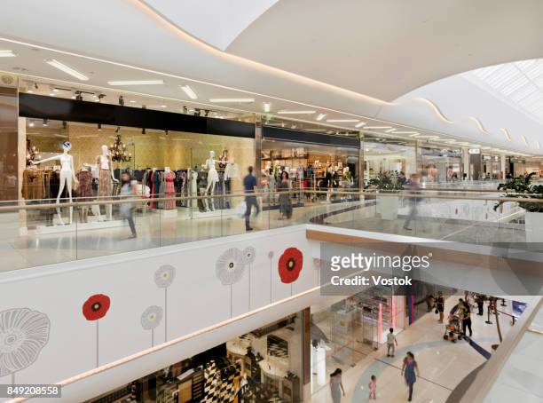 inside a large shopping mall in almaty - shoppingcenter stock-fotos und bilder