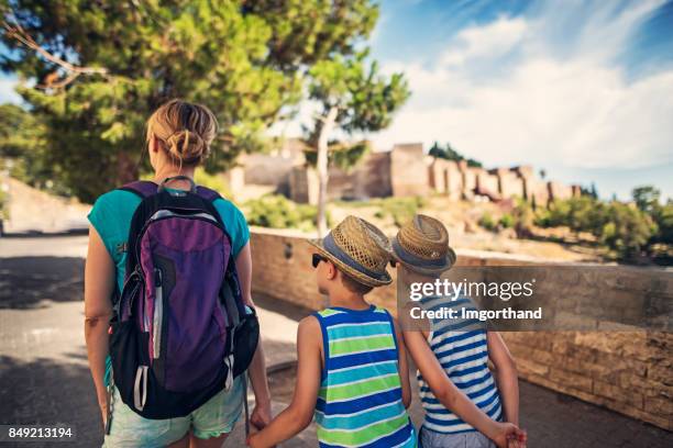 mother and sons sightseeing city of malaga, andalusia, spain - alcazaba of málaga stock pictures, royalty-free photos & images