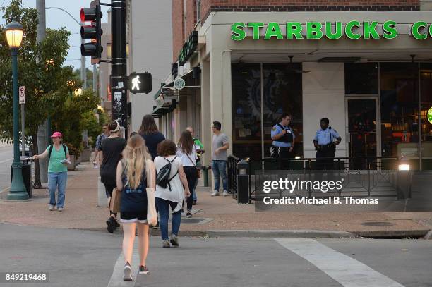 University City Police Officers stand outside a Starbucks prior to a protest action following a not guilty verdict on September 18, 2017 in...