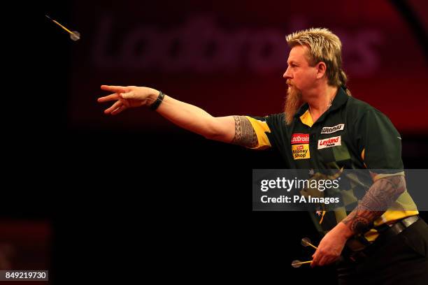 Simon Whitlock in action during the Ladbrokes.com World Darts Championship at Alexandra Palace, London.