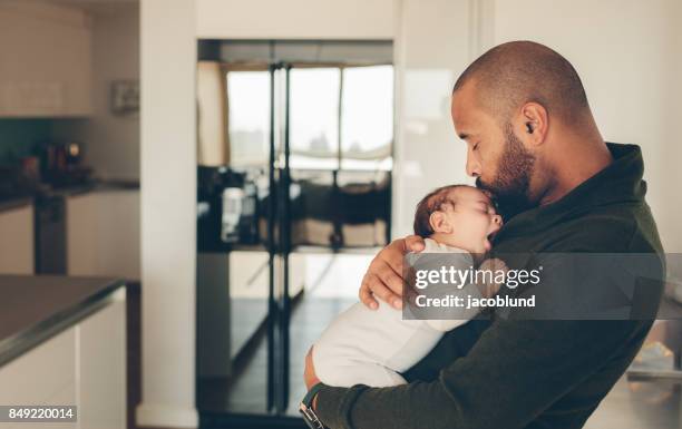 Cute little boy in his father's arms