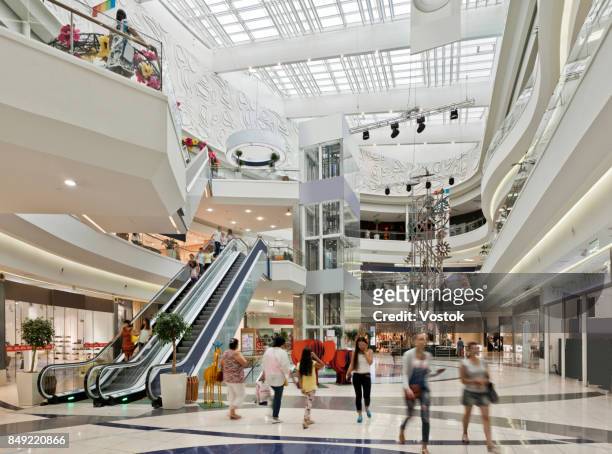 inside a large shopping mall in almaty - shoppingcenter stock-fotos und bilder