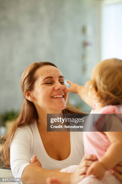 cheerful baby plays with her mom - baby hands pointing stock pictures, royalty-free photos & images