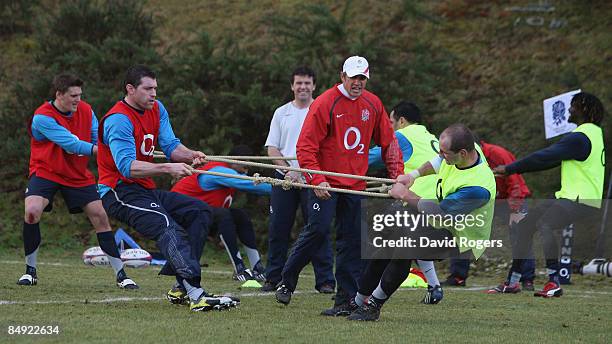 Brian Smith, the England back coach looks on as Nick Kennedy and Steve Borthwick take part in strength training during the England training session...