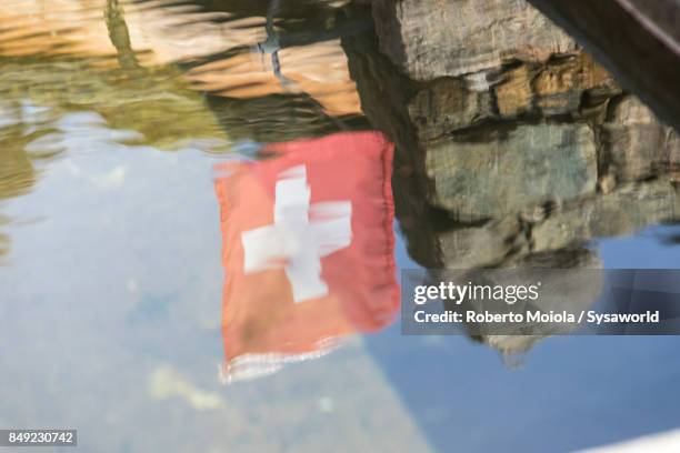 swiss flag, san romerio alp, switzerland - brusio grisons stock pictures, royalty-free photos & images