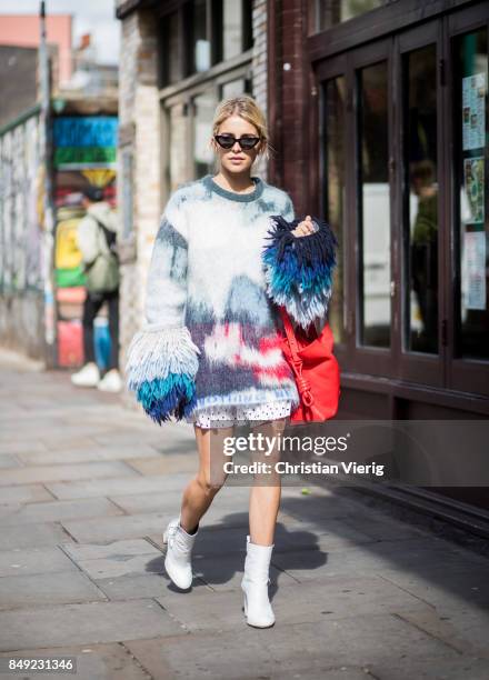 Caroline Daur wearing knit dress, ankle boots, red bag outside Marques Almeida during London Fashion Week September 2017 on September 18, 2017 in...