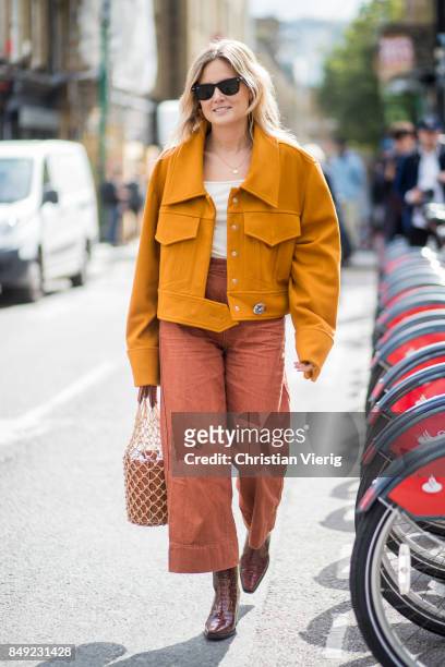 Lucy Williams wearing orange jacket, bucket bag outside Marques Almeida during London Fashion Week September 2017 on September 18, 2017 in London,...