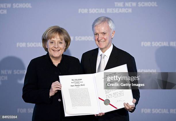 German Chancellor Angela Merkel and President of the New School For Social Research, Bob Kerrey present the certificate during the presentation of...