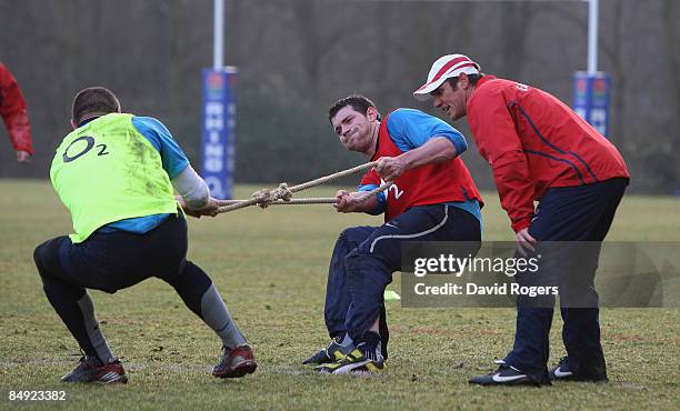 Brian Smith, the England back coach looks on as Nick Kennedy and Steve Borthwick take part in strength training during the England training session...