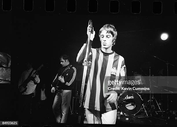 Singer Liam Gallagher performing , with rock group Oasis at the Wedgewood Rooms, Portsmouth, 2nd May 1994. To his right is rhythm guitarist Paul...