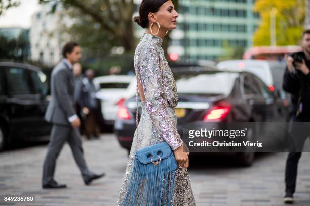 Giovanna Engelbert wearing glitter dress, JW Anderson bag with fringes outside Emilia Wickstead during London Fashion Week September 2017 on...