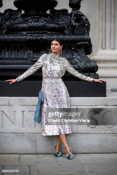 Giovanna Engelbert wearing glitter dress, JW Anderson bag with fringes outside Emilia Wickstead during London Fashion Week September 2017 on...