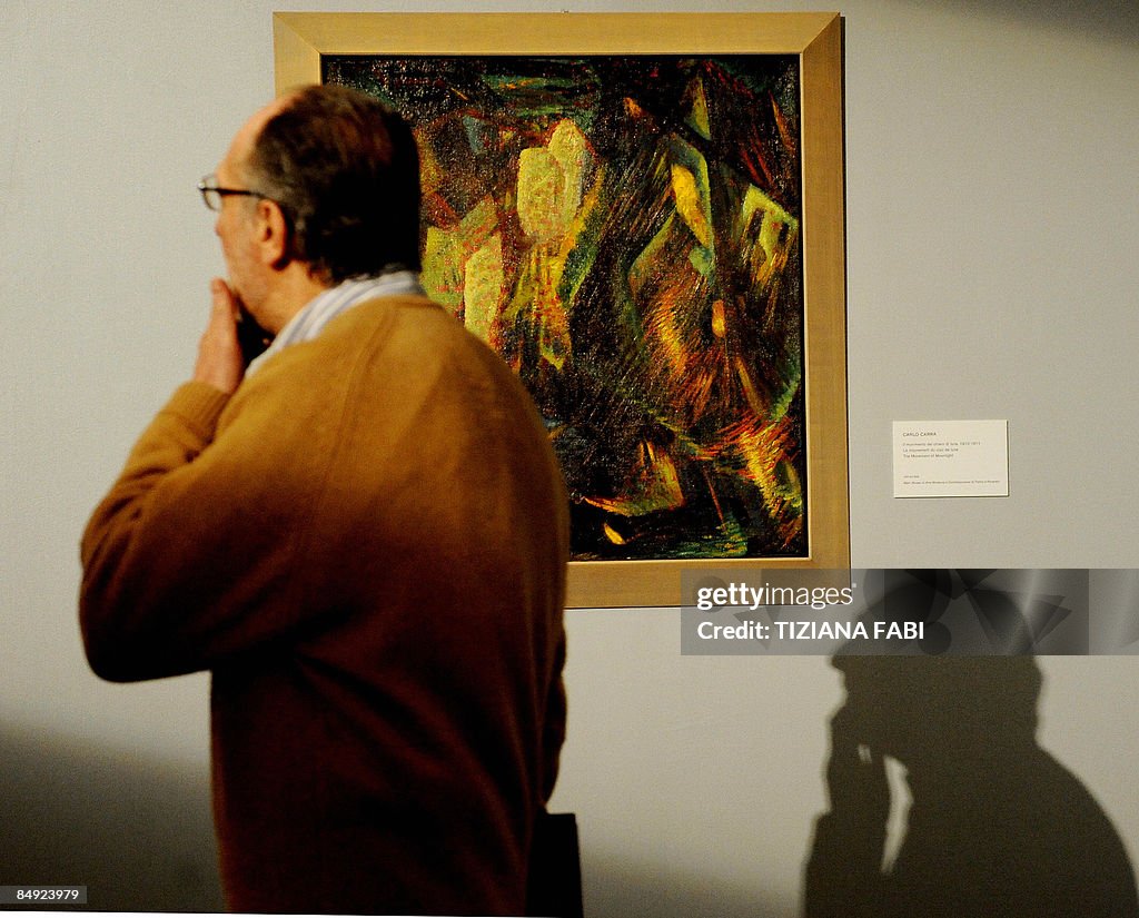 A man walks next to a Carlo Carra's oil